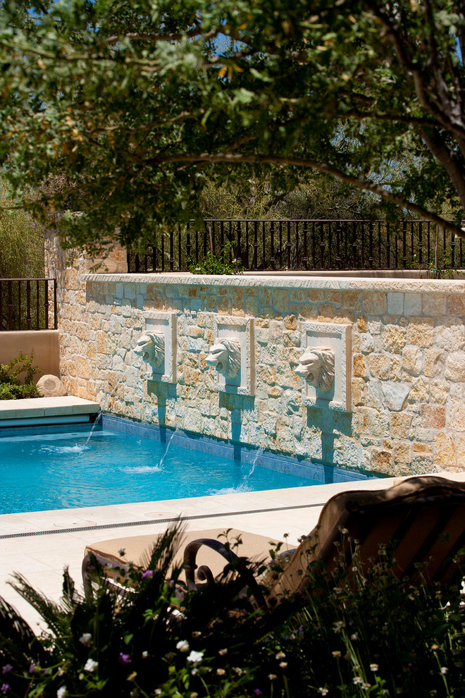 Photo of a mid-sized mediterranean rectangular pool in Phoenix with a water feature.