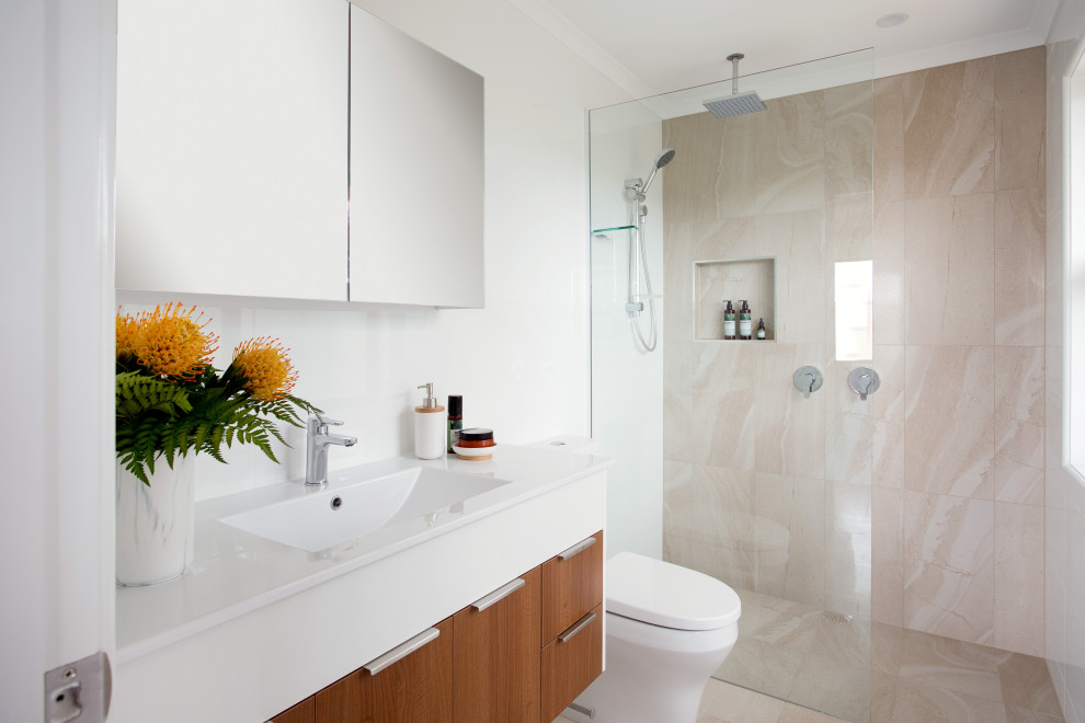 Photo of a contemporary wet room bathroom in Brisbane with white cabinets, a one-piece toilet, beige tile, white walls, beige floor, white benchtops, a single vanity, a drop-in sink, a floating vanity and flat-panel cabinets.