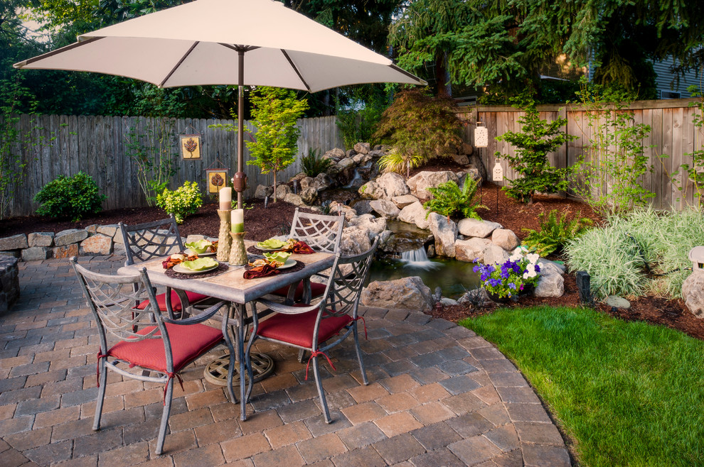Design ideas for a contemporary patio in Portland with brick pavers and a water feature.