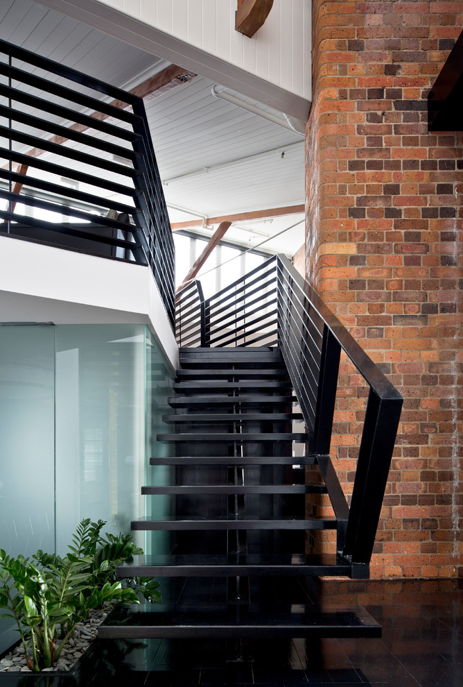 Photo of a large industrial wood straight staircase in Brisbane with open risers and metal railing.