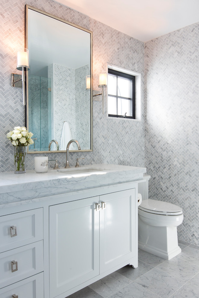Design ideas for a transitional master bathroom in Orange County with a freestanding tub, white walls, recessed-panel cabinets, white cabinets, white tile, marble, an undermount sink, white floor and white benchtops.