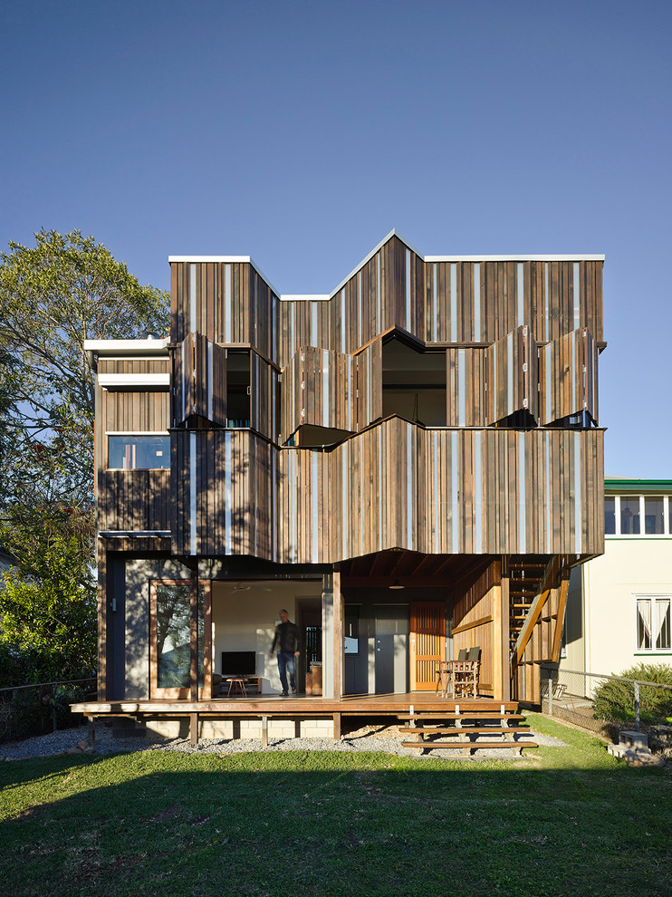 This is an example of a large contemporary two-storey brown exterior in Brisbane with wood siding.