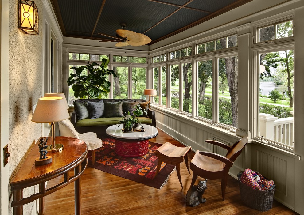 Design ideas for a traditional sunroom in Minneapolis with brown floor.