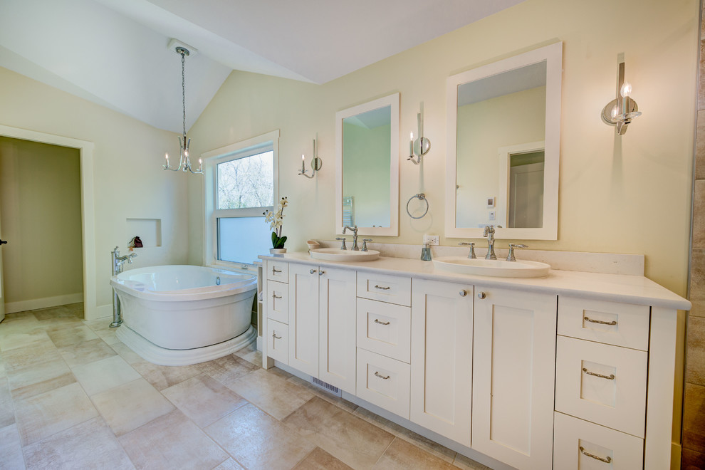 Inspiration for a mid-sized transitional 3/4 ceramic tile and beige floor freestanding bathtub remodel in Vancouver with shaker cabinets, white cabinets, a two-piece toilet, beige walls, an undermount sink, quartz countertops and a hinged shower door