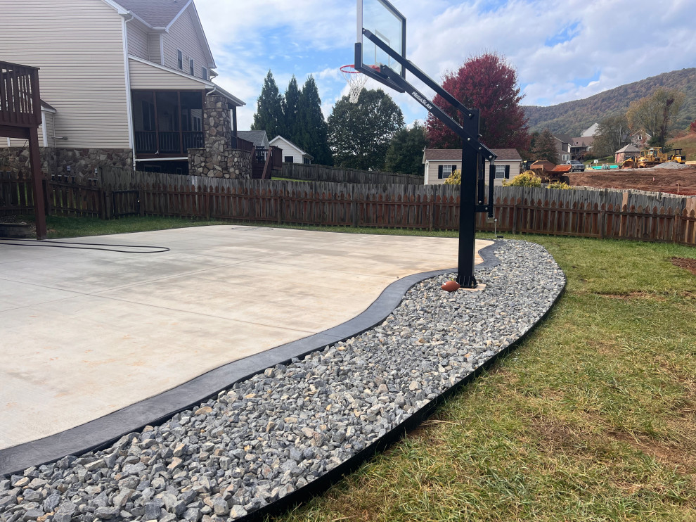 This is an example of a mid-sized modern backyard full sun outdoor sport court in Other with with rock feature and gravel.