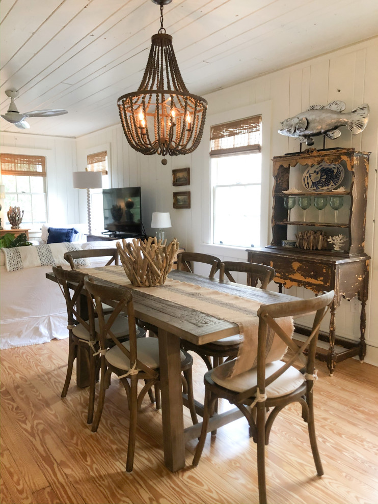 Photo of a mid-sized beach style kitchen/dining combo in Atlanta with white walls, light hardwood floors and beige floor.