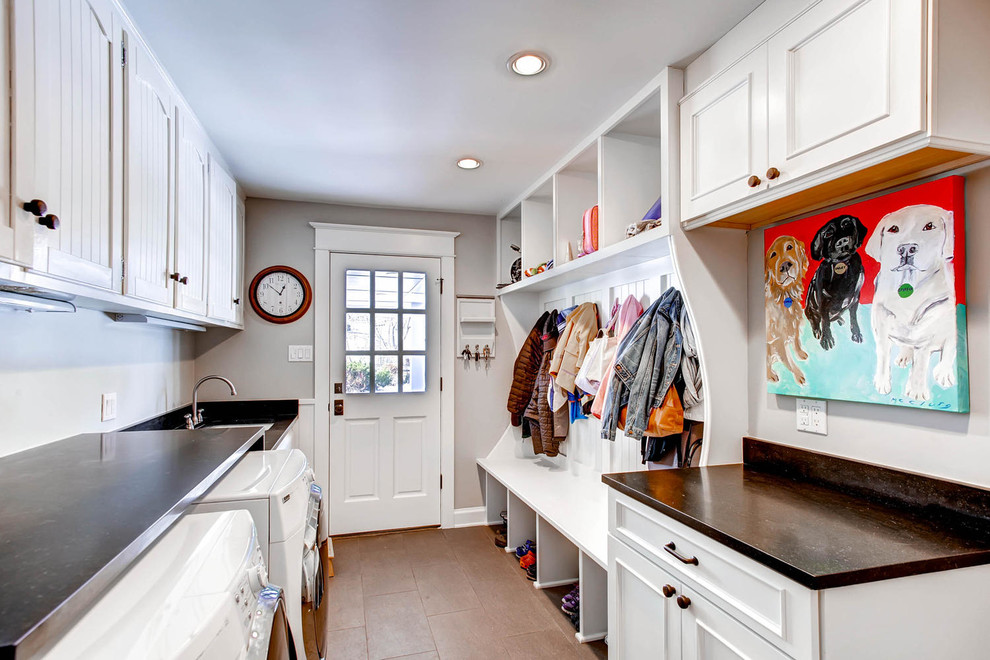 Design ideas for a traditional galley utility room in Denver with recessed-panel cabinets, white cabinets, grey walls, a side-by-side washer and dryer, brown floor and brown benchtop.