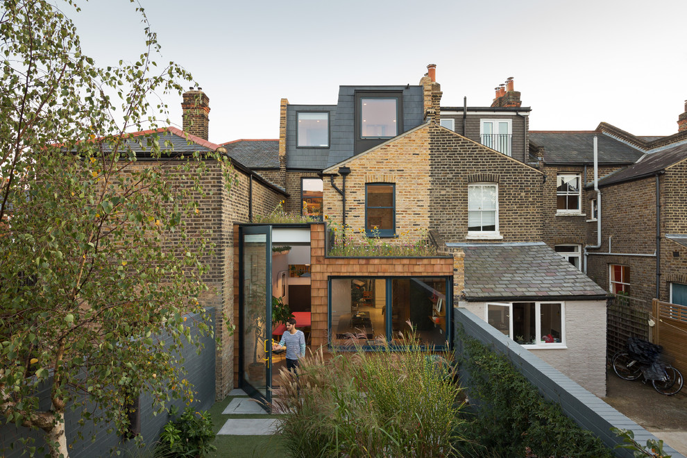 Inspiration for a mid-sized contemporary one-storey brick beige townhouse exterior in London.