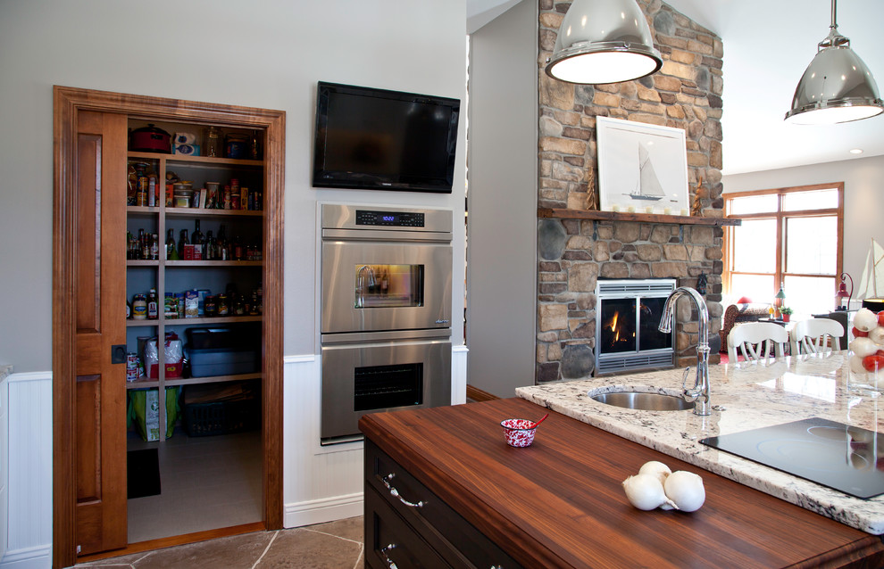 Inspiration for a large transitional u-shaped slate floor and brown floor open concept kitchen remodel with a farmhouse sink, shaker cabinets, white cabinets, granite countertops, yellow backsplash, subway tile backsplash, stainless steel appliances and two islands