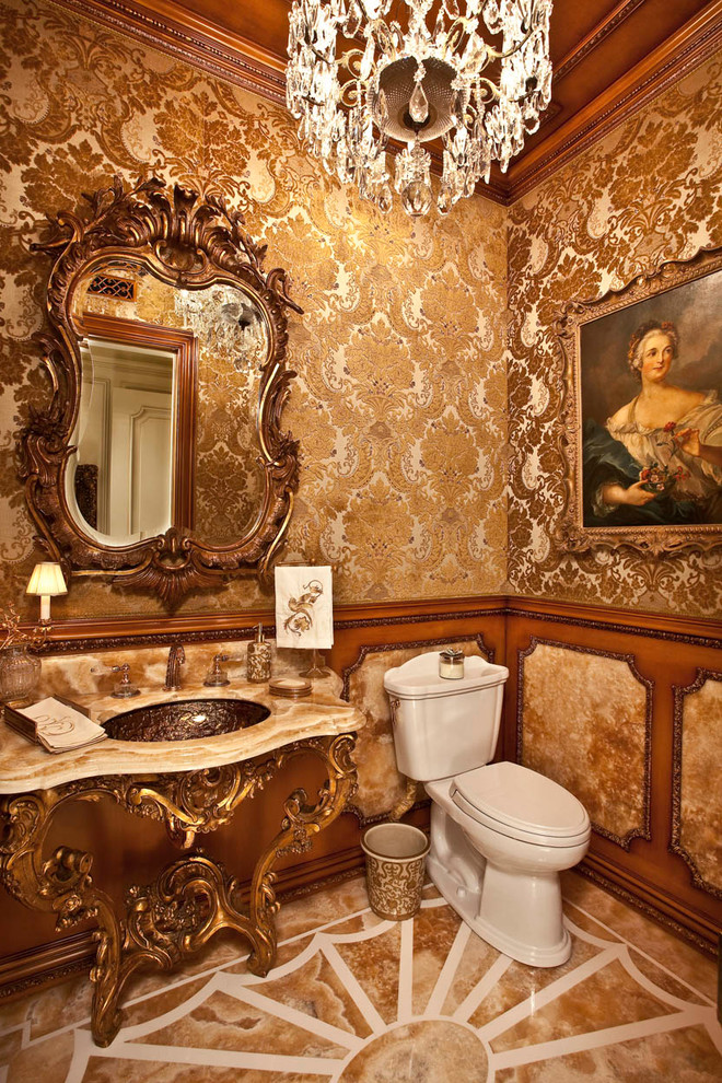 This is an example of a traditional powder room in Orange County with an undermount sink and a two-piece toilet.
