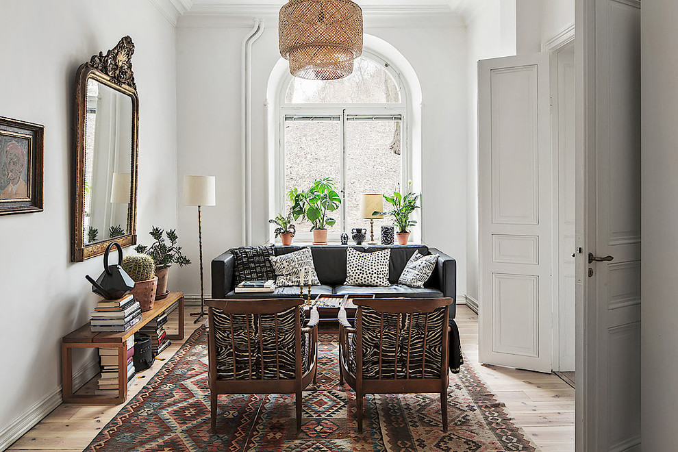 Design ideas for a large scandinavian formal enclosed living room in Stockholm with white walls, light hardwood floors, no fireplace and no tv.
