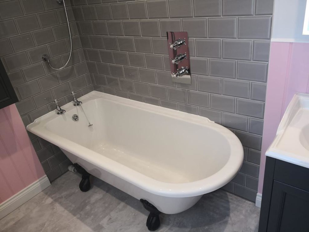 Inspiration for a medium sized victorian ensuite bathroom in Sussex with shaker cabinets, black cabinets, a freestanding bath, a shower/bath combination, a two-piece toilet, grey tiles, metro tiles, pink walls, porcelain flooring, a built-in sink, beige floors and a hinged door.