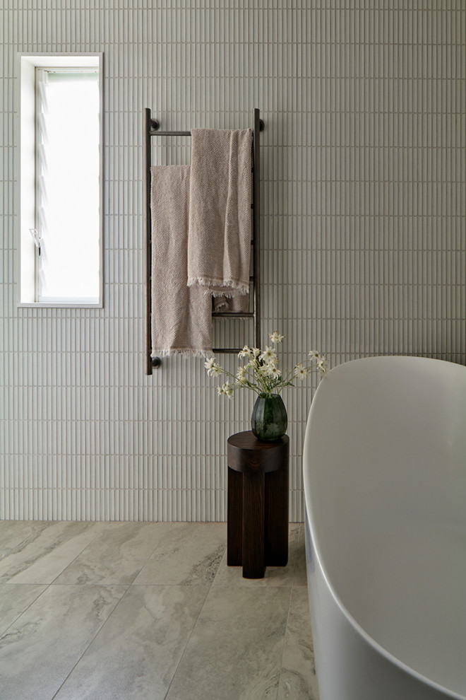Пример оригинального дизайна: главная ванная комната среднего размера в современном стиле с фасадами в стиле шейкер, белыми фасадами, отдельно стоящей ванной, открытым душем, унитазом-моноблоком, белой плиткой, плиткой из травертина, белыми стенами, полом из травертина, врезной раковиной, мраморной столешницей, разноцветным полом, открытым душем, белой столешницей, нишей, тумбой под две раковины, встроенной тумбой и панелями на стенах