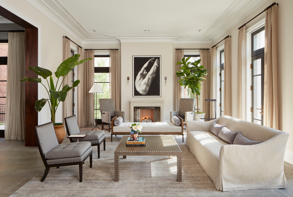 Design ideas for an expansive transitional formal enclosed living room in Chicago with limestone floors, a standard fireplace, no tv, beige walls and beige floor.
