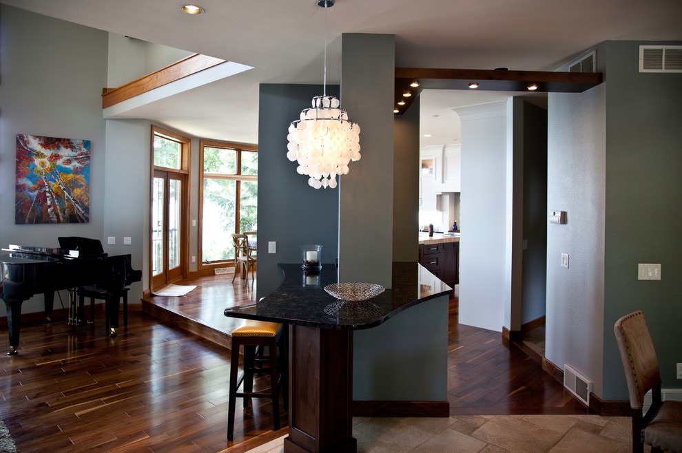 Small transitional medium tone wood floor and brown floor great room photo with blue walls and no fireplace