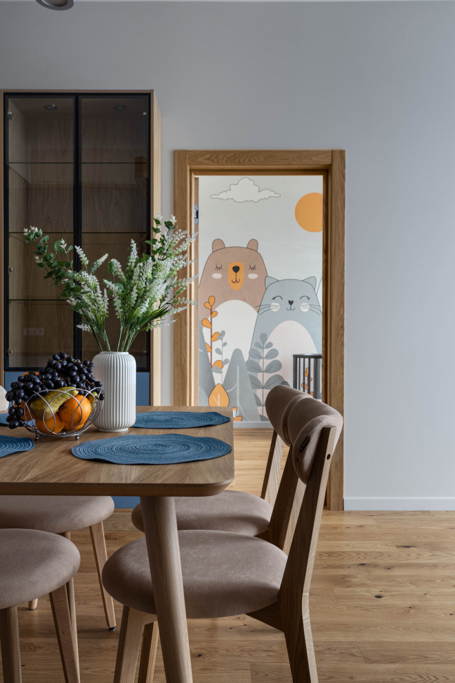 Design ideas for a medium sized scandi open plan dining room in Saint Petersburg with grey walls, medium hardwood flooring, no fireplace and brown floors.