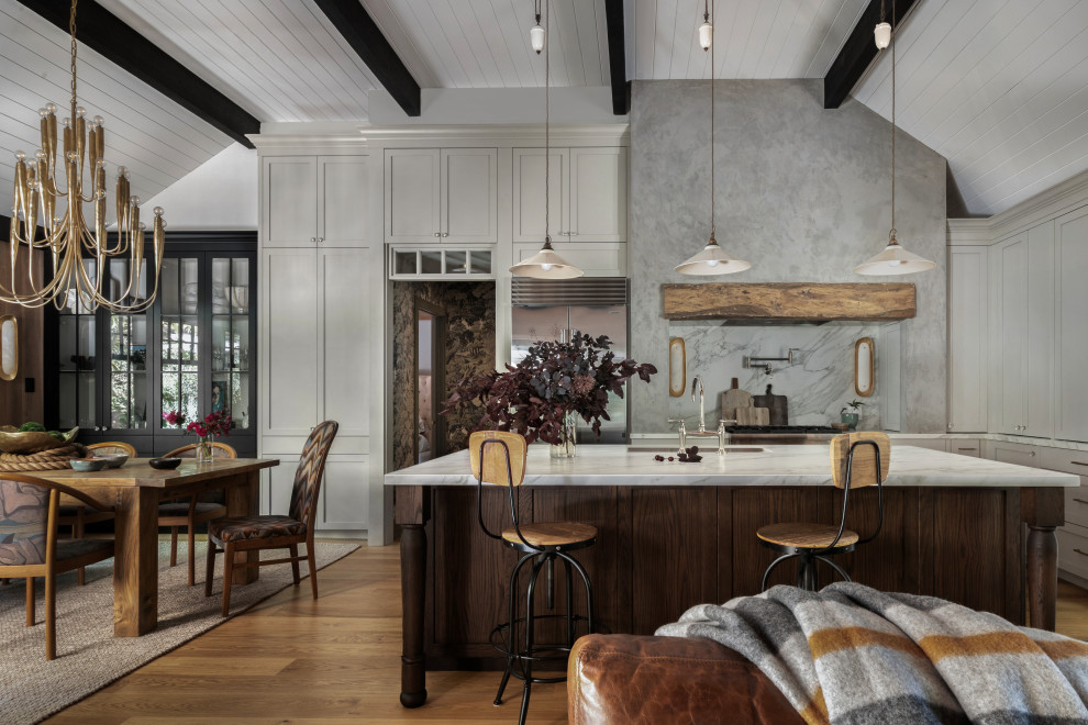 Inspiration for a transitional l-shaped medium tone wood floor, brown floor, exposed beam and shiplap ceiling kitchen remodel in San Francisco with an undermount sink, shaker cabinets, gray cabinets, gray backsplash, stone slab backsplash, stainless steel appliances, an island and white countertops