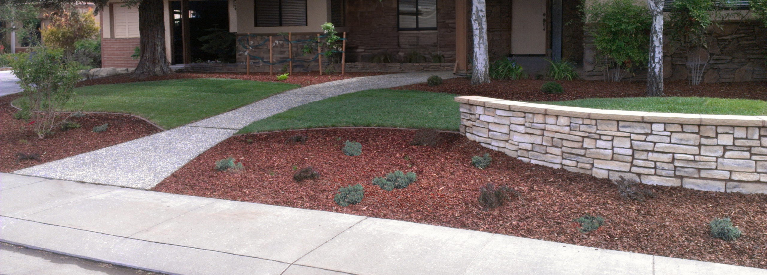Flowing Lawn and Plantings Extend Across the Front Yard