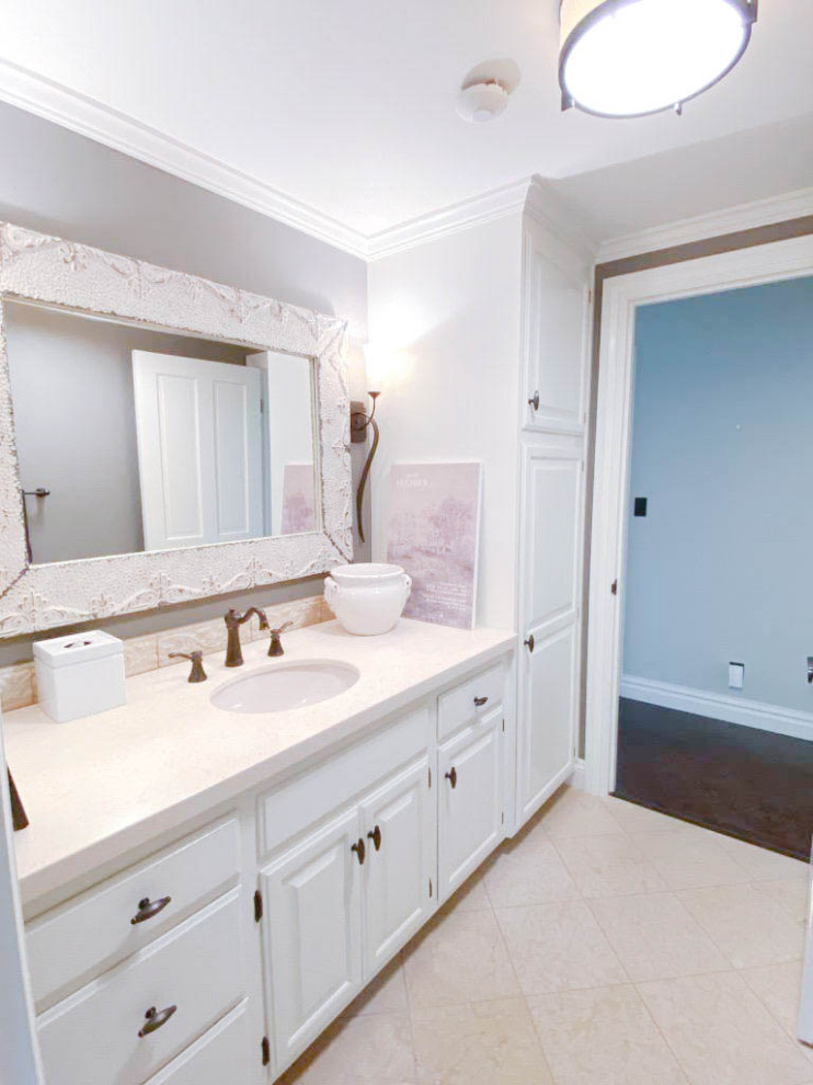 Photo of a small eclectic 3/4 bathroom with raised-panel cabinets, a built-in vanity, beige cabinets, an alcove shower, a two-piece toilet, beige tile, brown walls, limestone floors, an undermount sink, limestone benchtops, beige floor, a hinged shower door, beige benchtops and a single vanity.