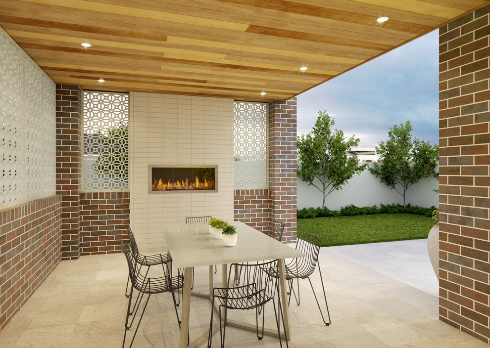 This is an example of a mid-sized modern backyard patio in Brisbane with with fireplace, natural stone pavers and a roof extension.