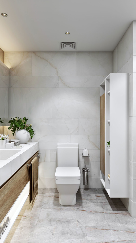 Small modern master bathroom in London with flat-panel cabinets, light wood cabinets, a corner tub, a corner shower, a wall-mount toilet, beige tile, ceramic tile, ceramic floors, tile benchtops, beige floor and beige benchtops.
