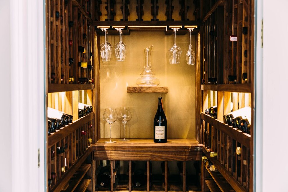 This is an example of a small transitional wine cellar in Los Angeles with marble floors and storage racks.