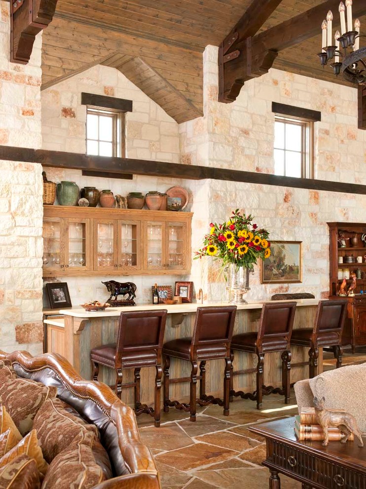 This is an example of a mediterranean galley home bar in Dallas with glass-front cabinets and medium wood cabinets.