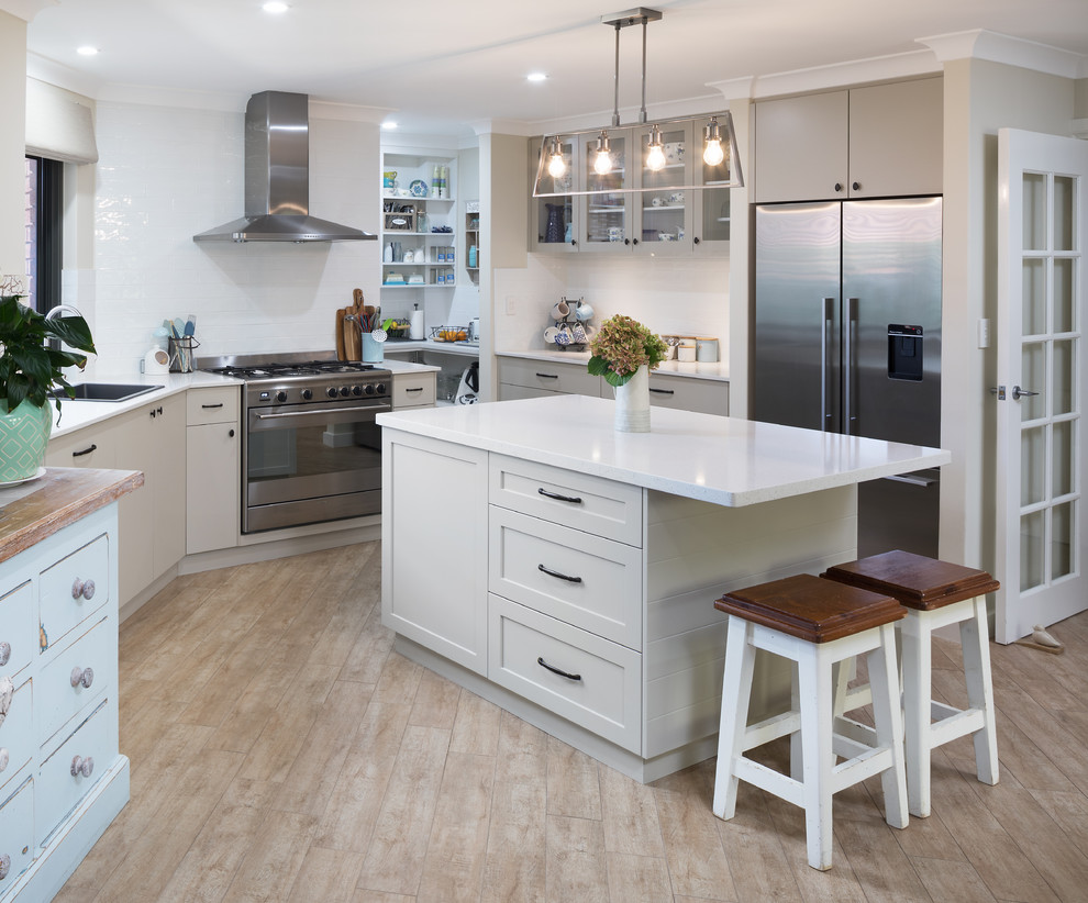 Transitional kitchen in Perth with a single-bowl sink, shaker cabinets, beige cabinets, quartz benchtops, white splashback, subway tile splashback, stainless steel appliances, with island and white benchtop.