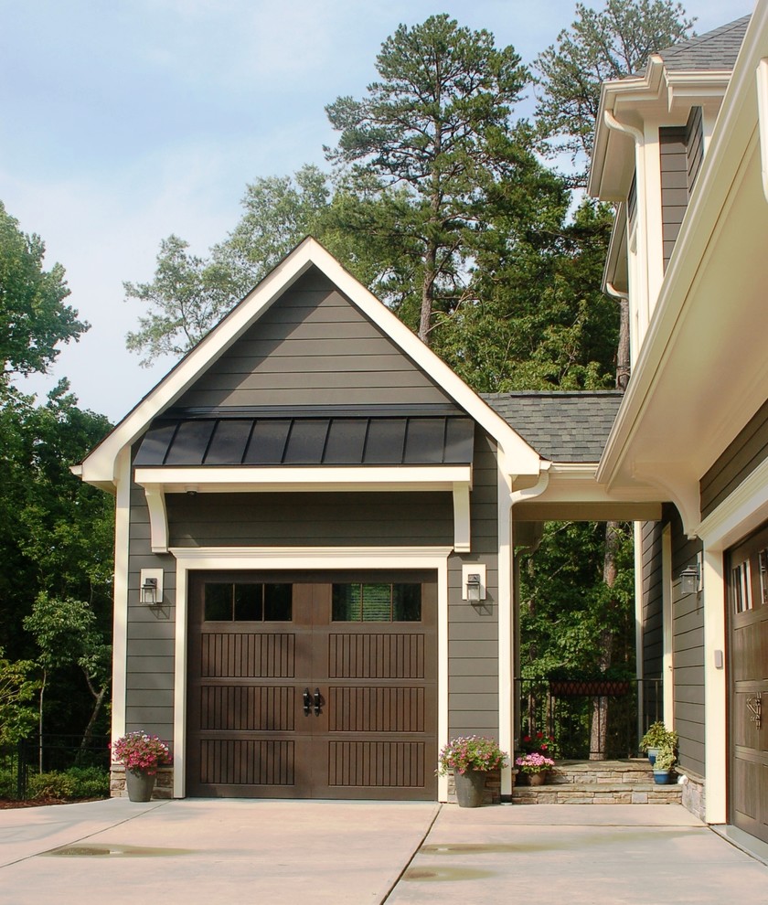 Example of an arts and crafts attached one-car garage design in Charlotte
