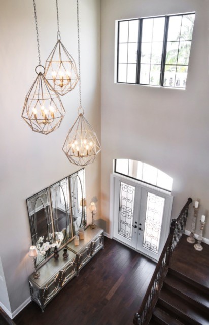 Example of a transitional double front door design in Miami with beige walls, engineered wood floors and a glass front door