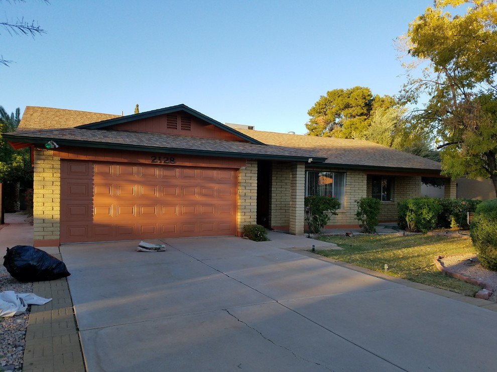 This is an example of a mid-sized transitional one-storey brick beige house exterior in Phoenix with a shingle roof.