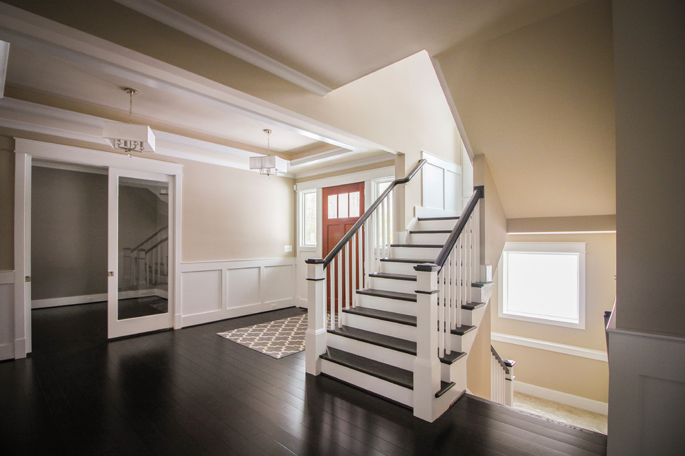 Photo of a large modern wood u-shaped staircase in DC Metro with wood risers and wood railing.