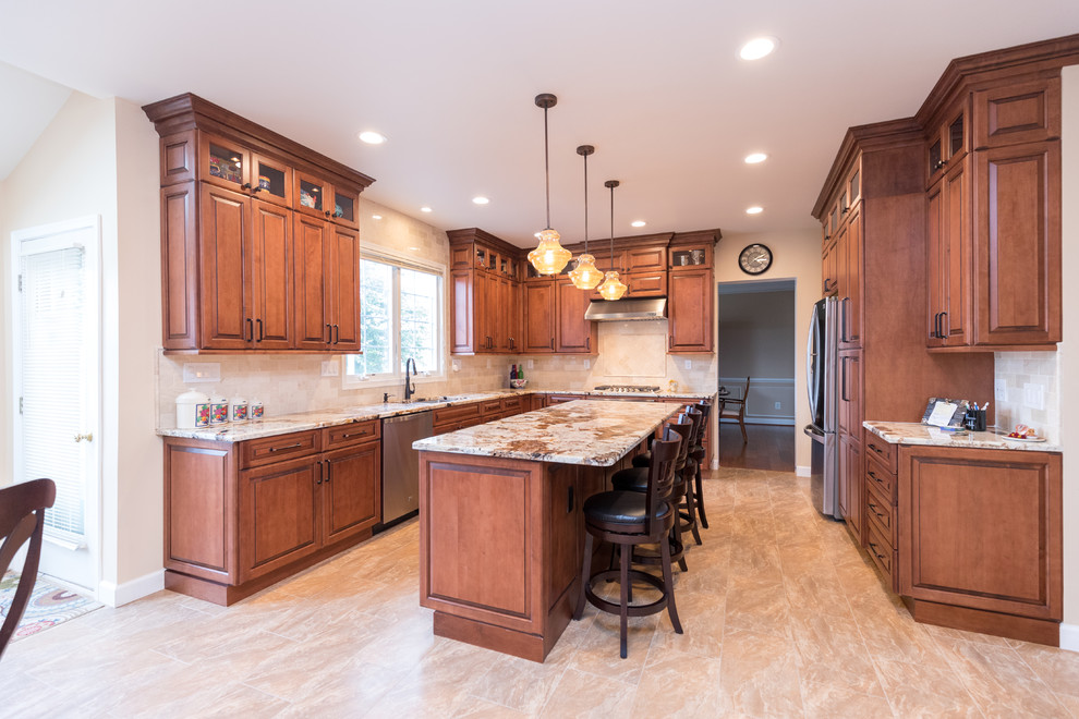 Design ideas for a mid-sized traditional l-shaped eat-in kitchen in DC Metro with an undermount sink, raised-panel cabinets, dark wood cabinets, granite benchtops, beige splashback, stone tile splashback, stainless steel appliances, porcelain floors, with island and beige floor.