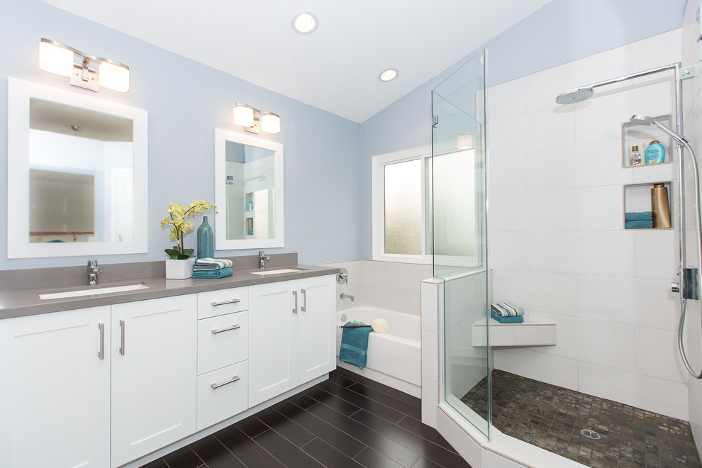 Photo of a mid-sized contemporary master bathroom in Orange County with a corner shower, an undermount sink, shaker cabinets, white cabinets, engineered quartz benchtops, gray tile, porcelain tile, blue walls, porcelain floors, an alcove tub, brown floor, grey benchtops and a hinged shower door.