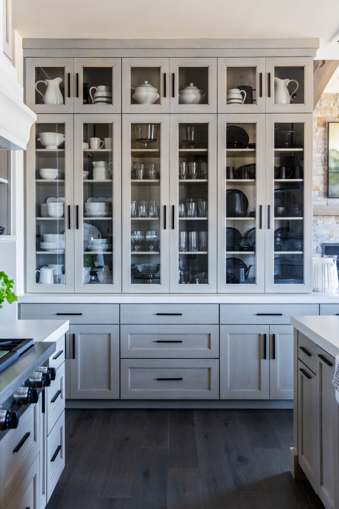 This is an example of a large country single-wall eat-in kitchen in Salt Lake City with shaker cabinets, beige cabinets, white splashback, stainless steel appliances, dark hardwood floors, with island, brown floor and yellow benchtop.