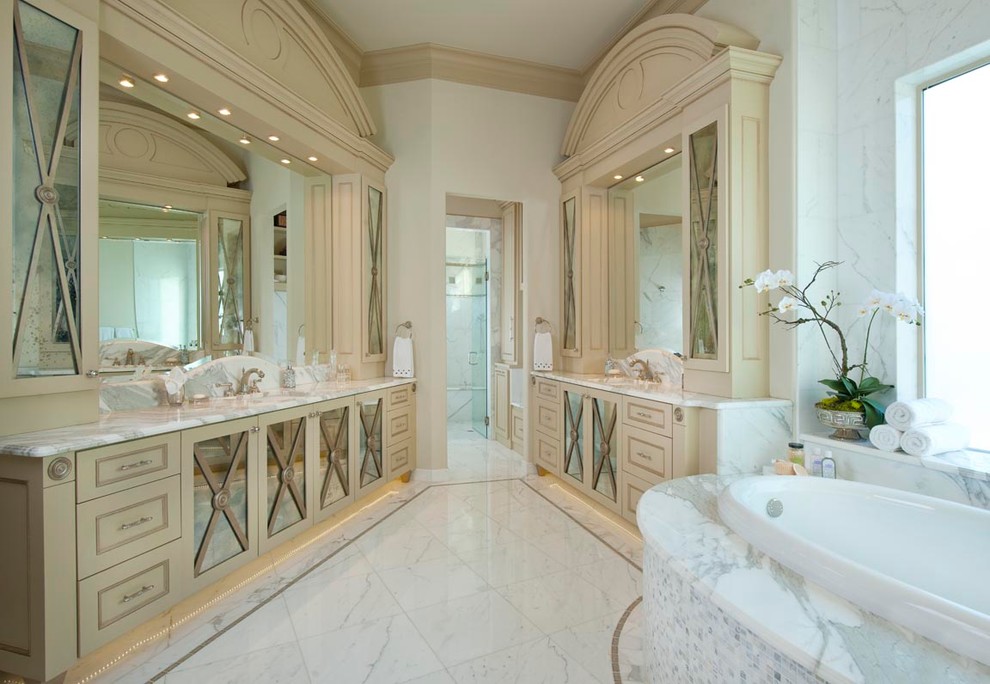 Photo of a mediterranean bathroom in Dallas with shaker cabinets, marble benchtops and marble.