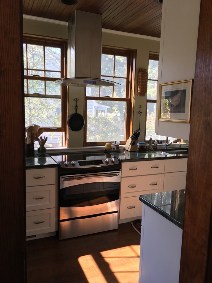 Example of a transitional u-shaped dark wood floor kitchen design in Boston with an undermount sink, shaker cabinets, white cabinets, granite countertops and stainless steel appliances