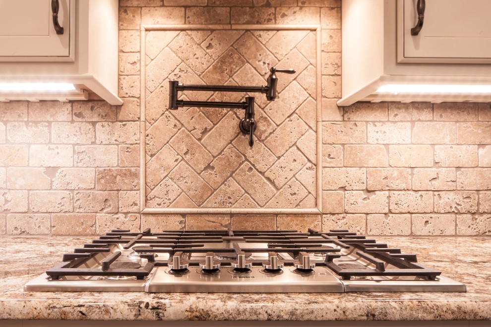 Inspiration for a mid-sized transitional u-shaped dark wood floor and brown floor eat-in kitchen remodel with a farmhouse sink, recessed-panel cabinets, white cabinets, granite countertops, beige backsplash, ceramic backsplash, stainless steel appliances and an island