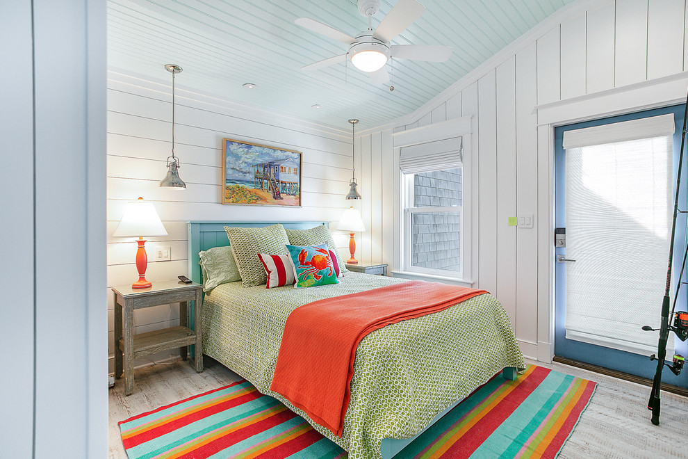 Inspiration for a beach style guest bedroom in Other with white walls and vinyl floors.