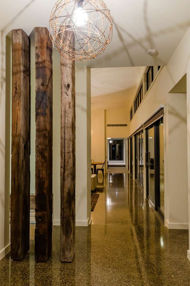 This is an example of a large contemporary foyer in Geelong with concrete floors.