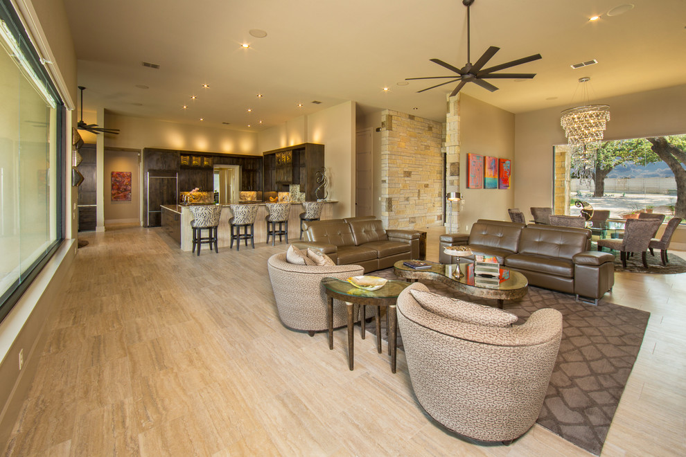 This is an example of a mid-sized mediterranean open concept living room in Austin with beige walls and porcelain floors.
