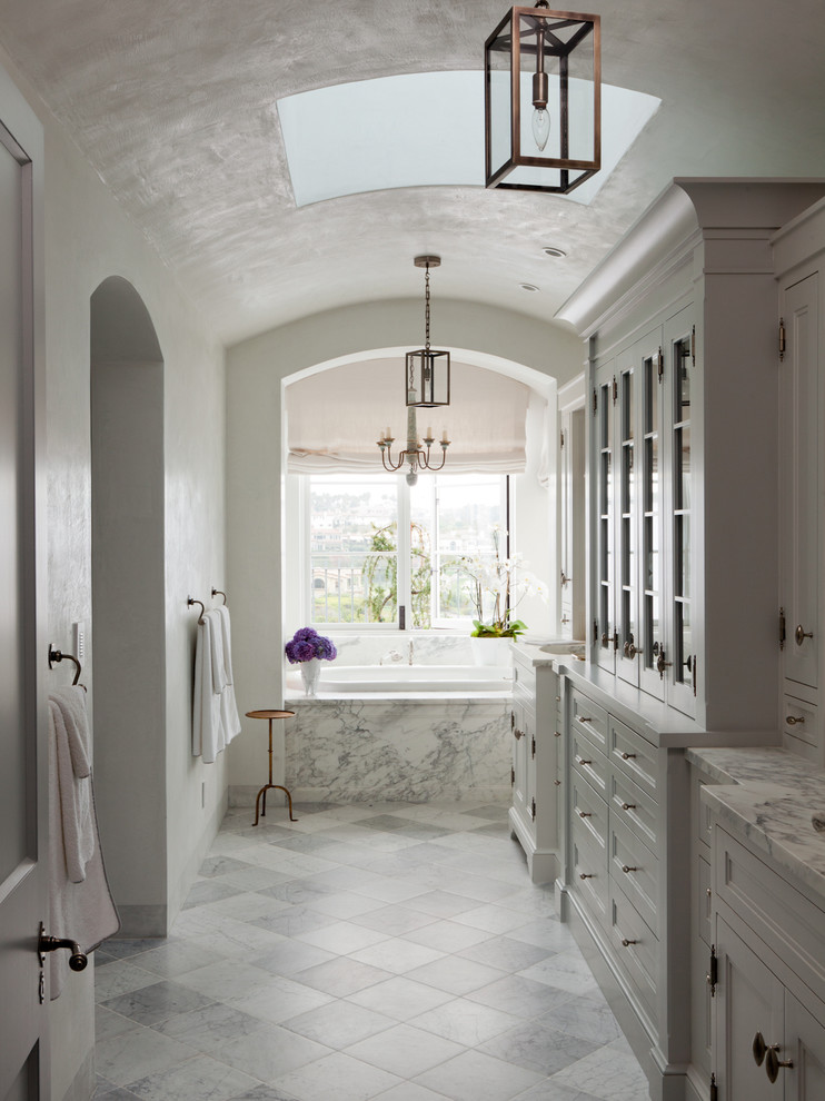 Photo of a mediterranean master bathroom in Orange County with a drop-in tub.