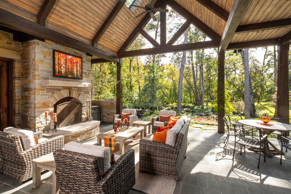 This is an example of a country backyard patio in Houston with with fireplace.