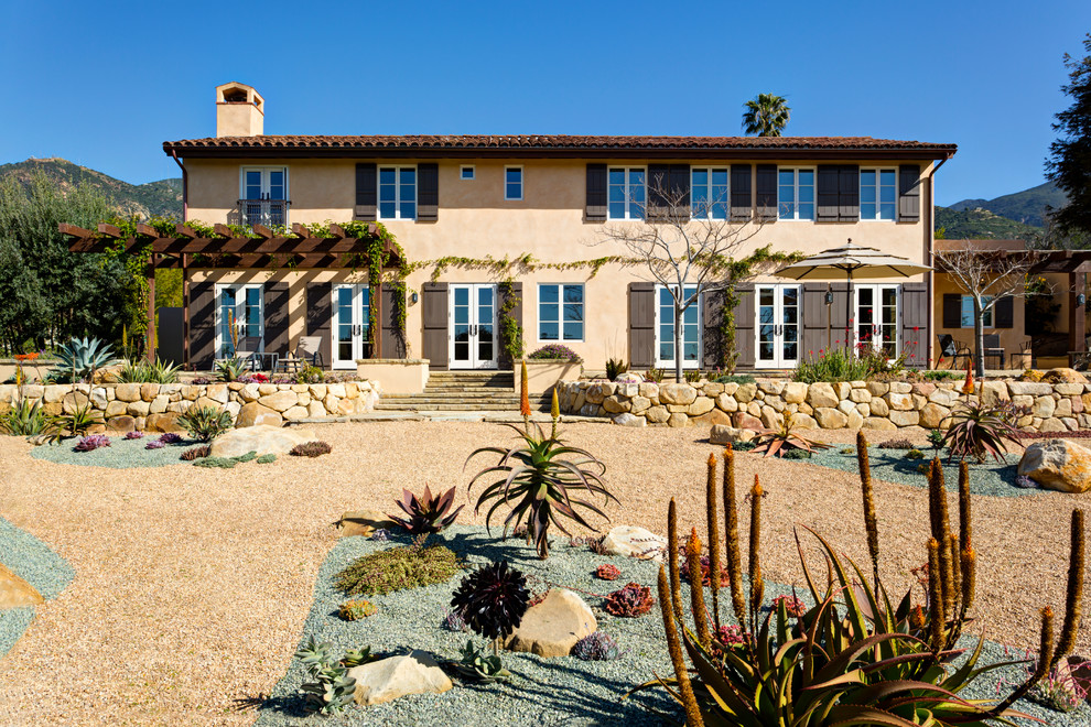 This is an example of a mediterranean two-storey stucco beige exterior in Santa Barbara.