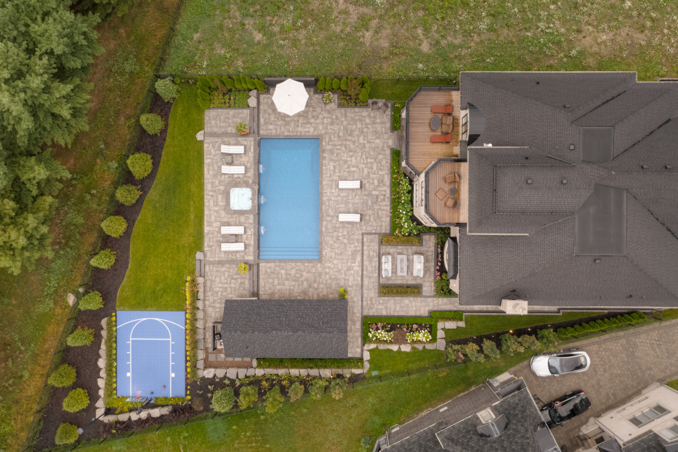 Inspiration for a large transitional backyard brick and rectangular lap pool landscaping remodel in Toronto