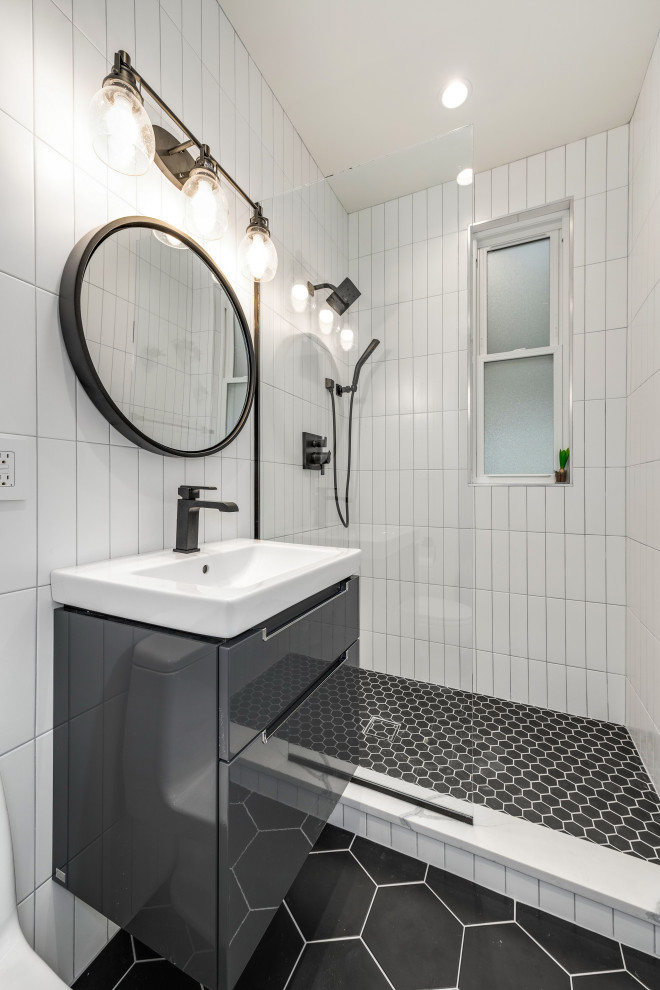 Inspiration for a small contemporary 3/4 bathroom in Chicago with grey cabinets, an alcove tub, an open shower, a one-piece toilet, white tile, porcelain tile, porcelain floors, solid surface benchtops, black floor, an open shower, white benchtops, an integrated sink and flat-panel cabinets.