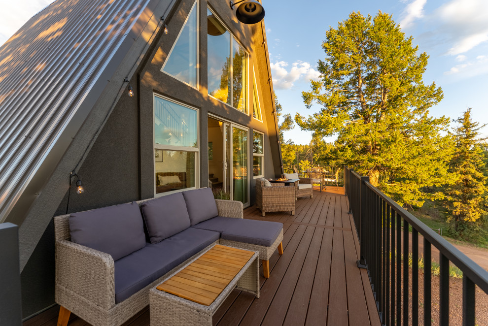Example of a small mountain style second story metal railing deck design with no cover