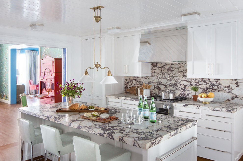 Inspiration for a mid-sized eclectic kitchen in Chicago with recessed-panel cabinets, white cabinets, marble benchtops, with island, marble splashback and stainless steel appliances.