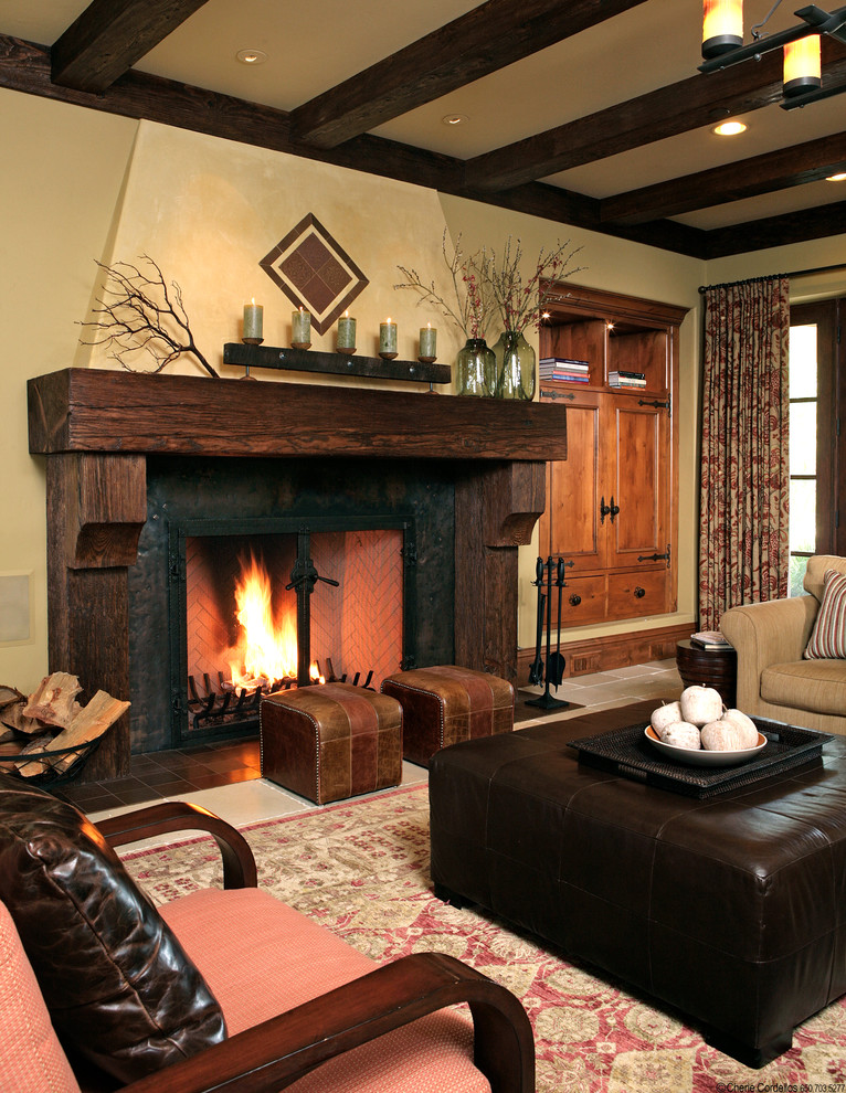 Country family room in San Francisco with beige walls, a standard fireplace and a wood fireplace surround.