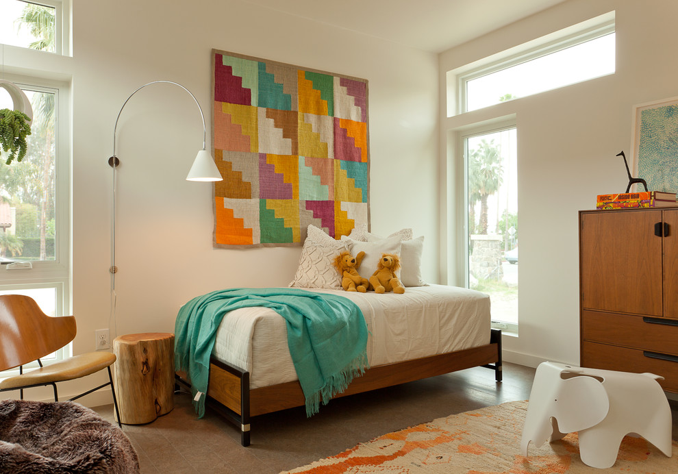 This is an example of a transitional kids' bedroom for girls in Los Angeles with white walls.